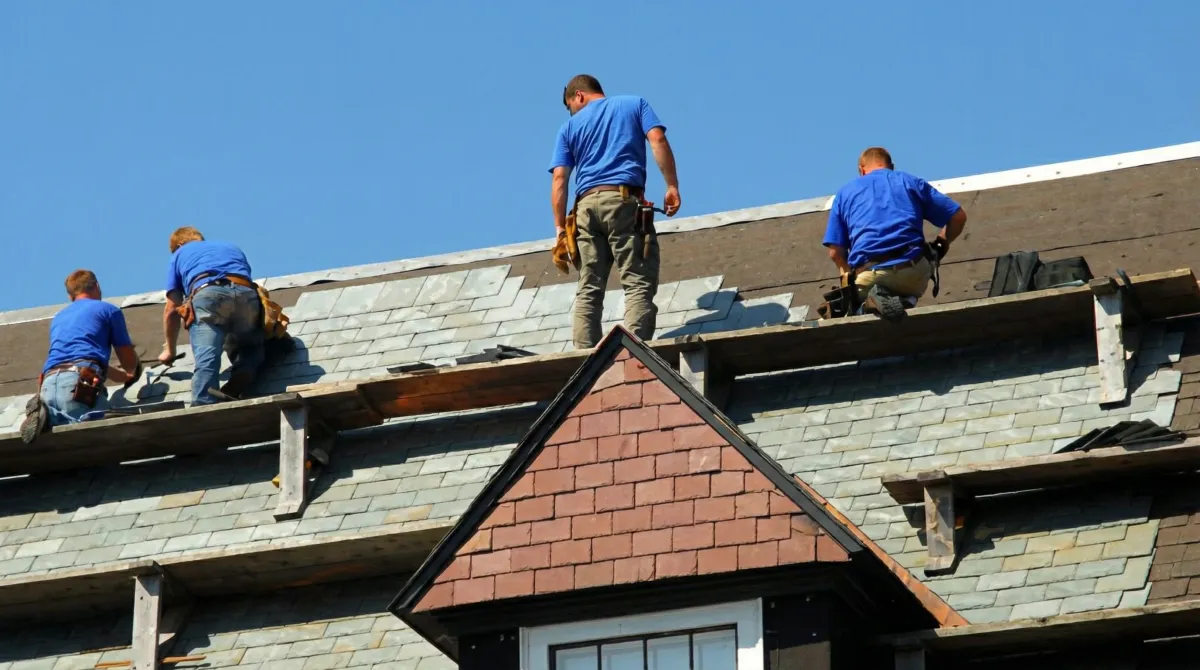 Roof replacement in progress with a team of professional contractors installing new shingles on a residential home in Orlando, FL