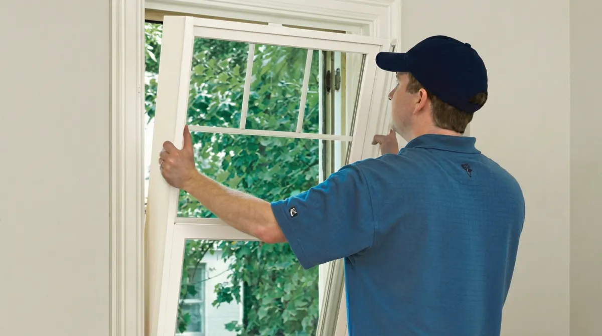 Professional contractors performing a residential window insulation and replacement service in Orlando, FL